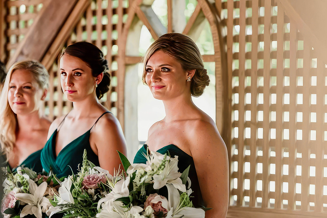 Smiling bridesmaids in updo hairstyles by Jennifer's Hair Boutique in Aurora